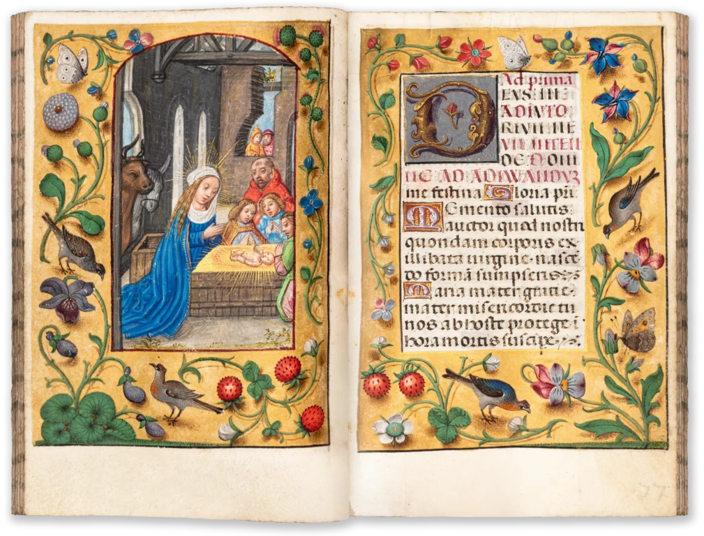 Flemish illuminated medieval manuscript opening with borders of flowers and animals and a miniature depicting the nativity of Christ.